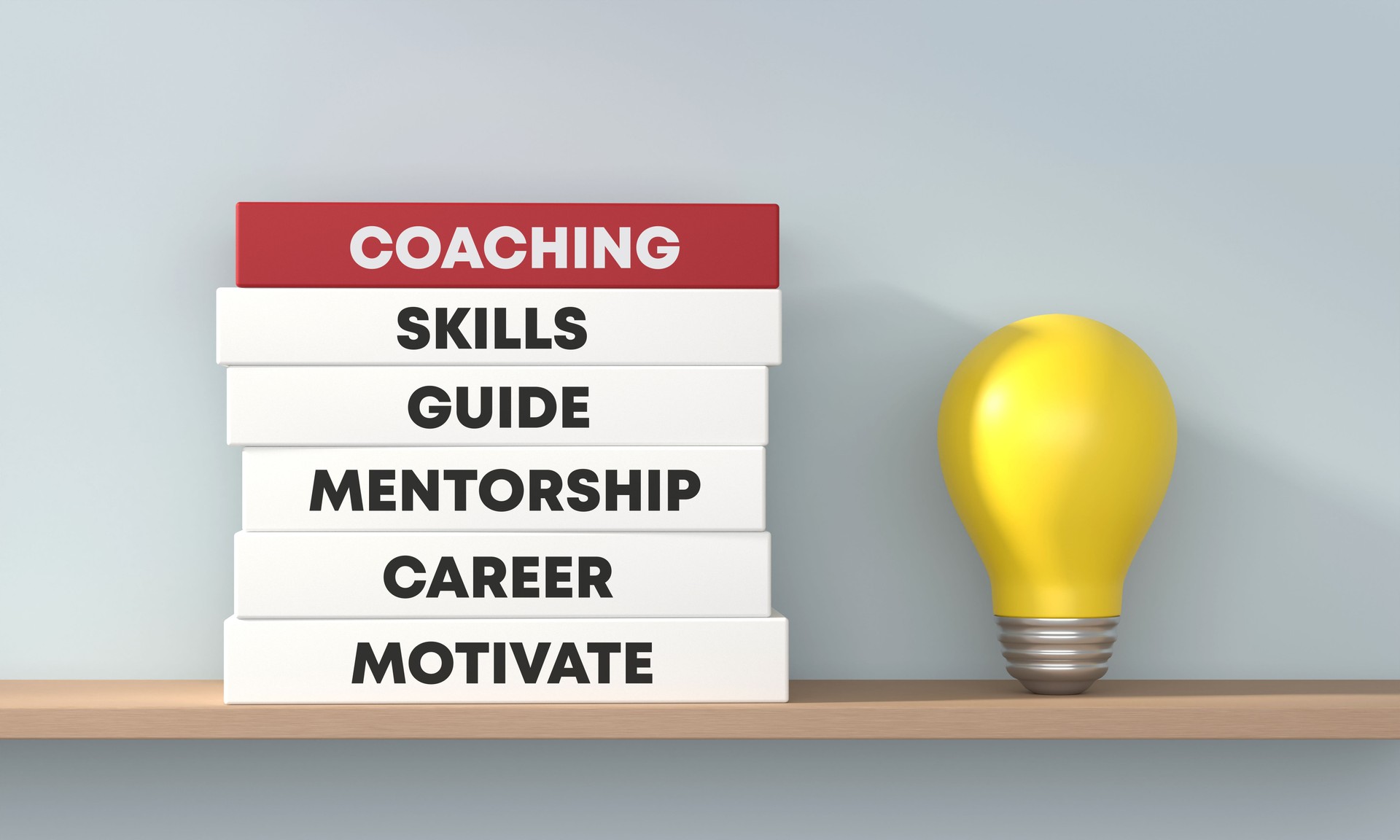 Livros de Coaching com lâmpada na prateleira