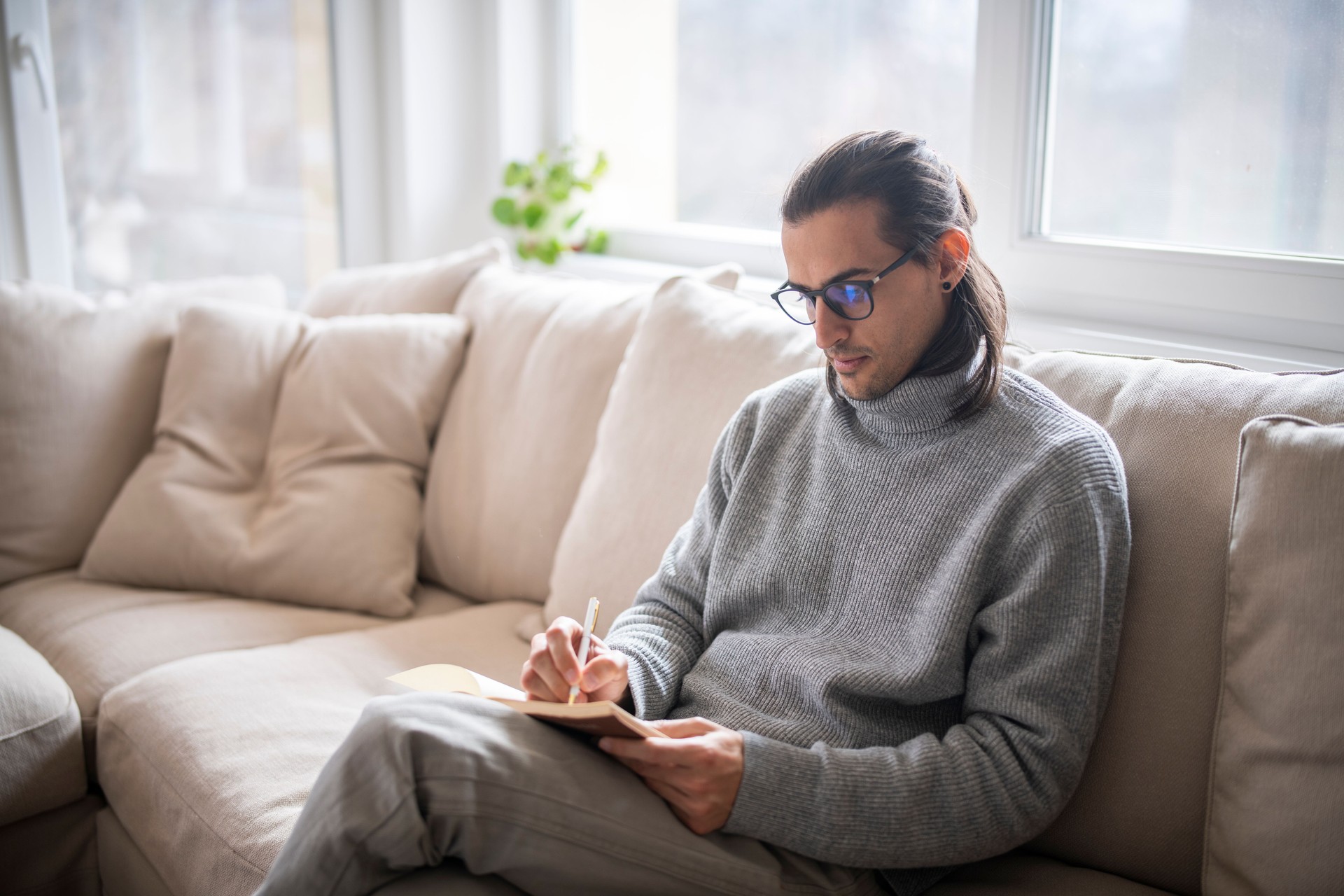 Male psychiatrist taking notes.